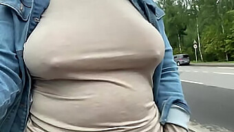 Mature Woman Exposes Herself Outdoors, Showcasing Her Sagging Breasts