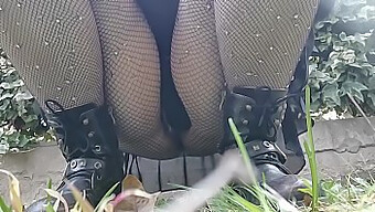 A Woman Desires To Urinate In A Public Park, Therefore, She Bends Over And Exposes Her Genitals While Wearing Fishnet Hosiery